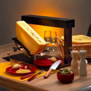 Mezza forma di formaggio Raclette francese su un tagliere